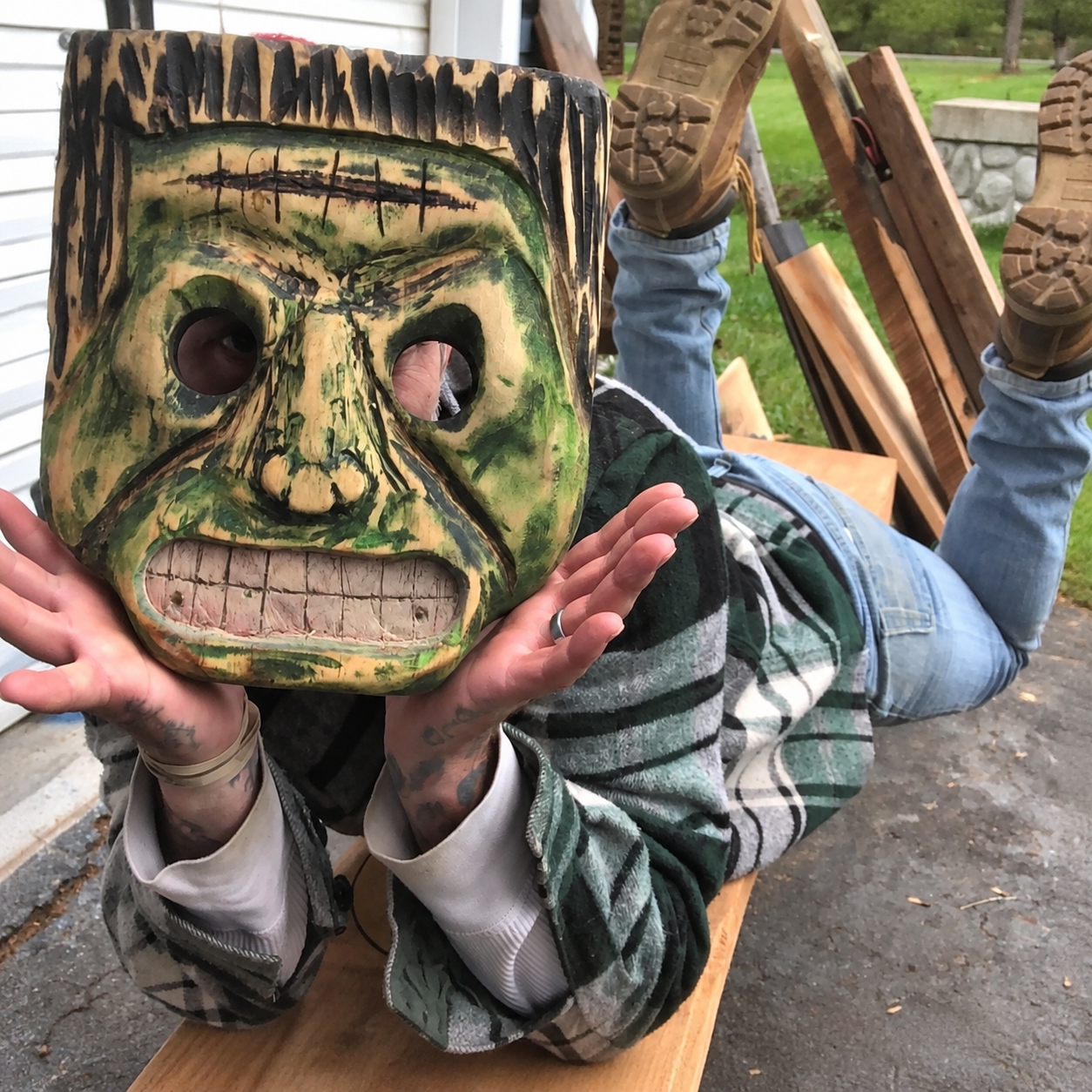 A maker playfully posing in a hand-carved Frankenstein mask by Dietrying13