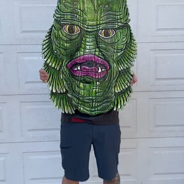 Maker holding a completed green Creature from the Black Lagoon-inspired mask by Rusty Anchor Trading